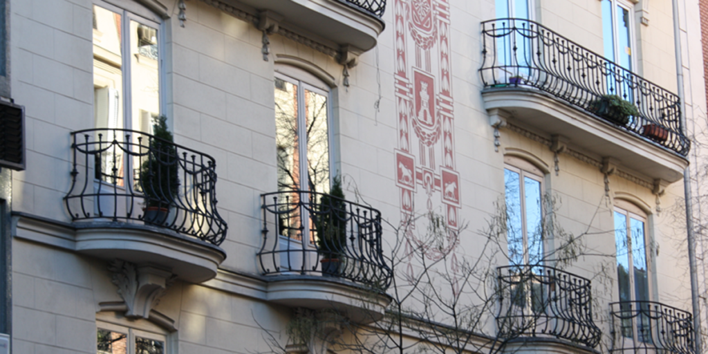 Una fachada con balcones con sus respectivos ventanales.